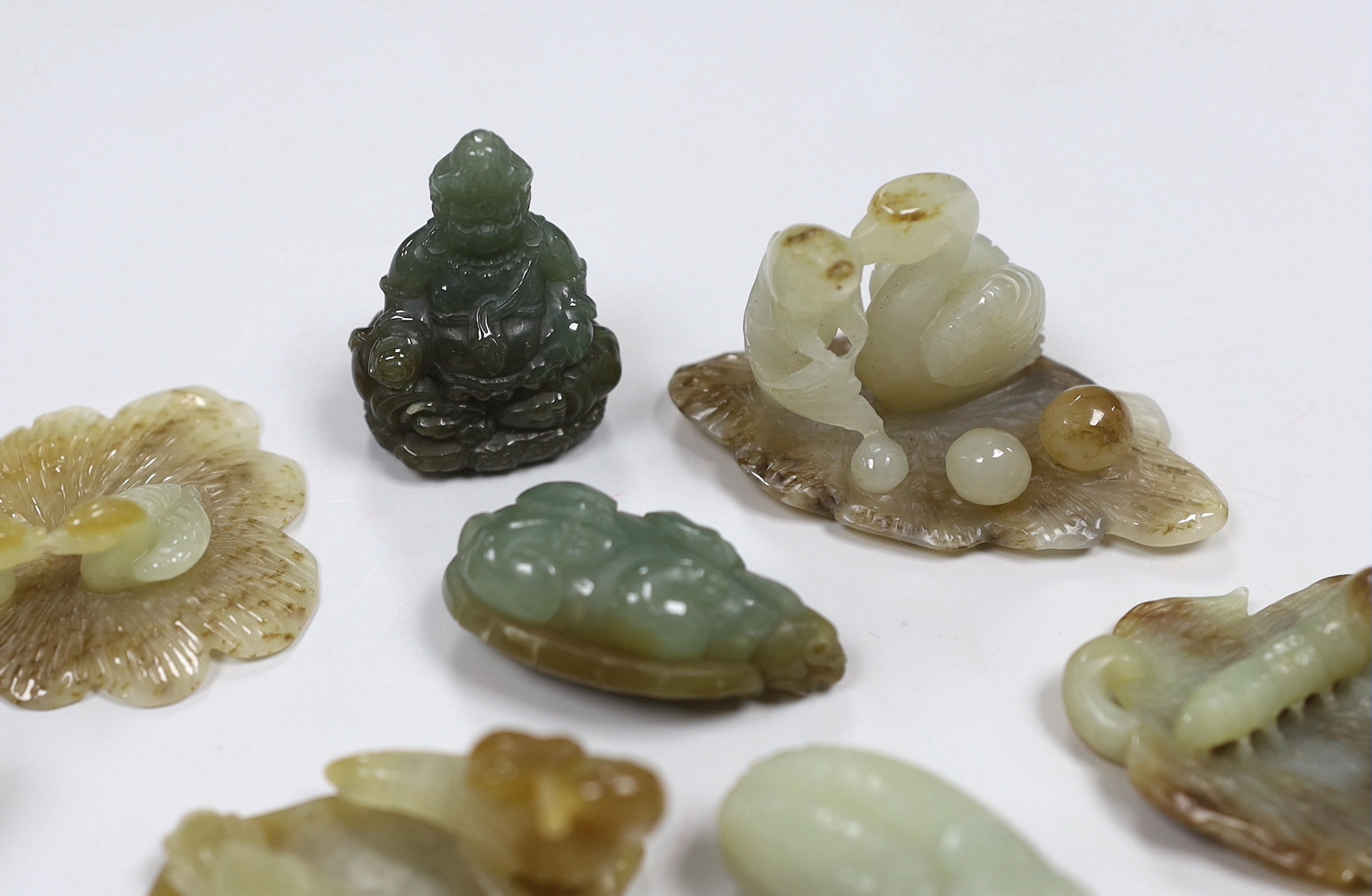 Nine Chinese jade carvings including ducks and caterpillars, the largest 9cm in length
